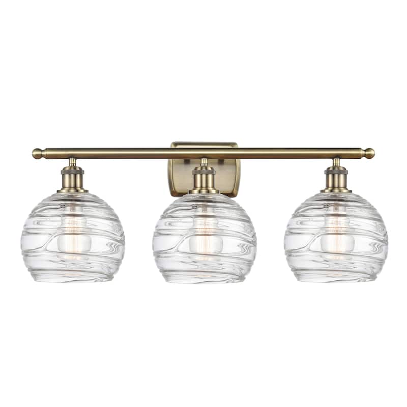 Innovations Lighting 516-3W-11-26 Athens Vanity Athens 3 Light 26" - Clear Deco Swirl / Antique Brass