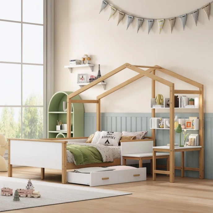 Children’s room with a playhouse canopy bed, an attached desk and bookshelves, and an under-the-bed drawer. 