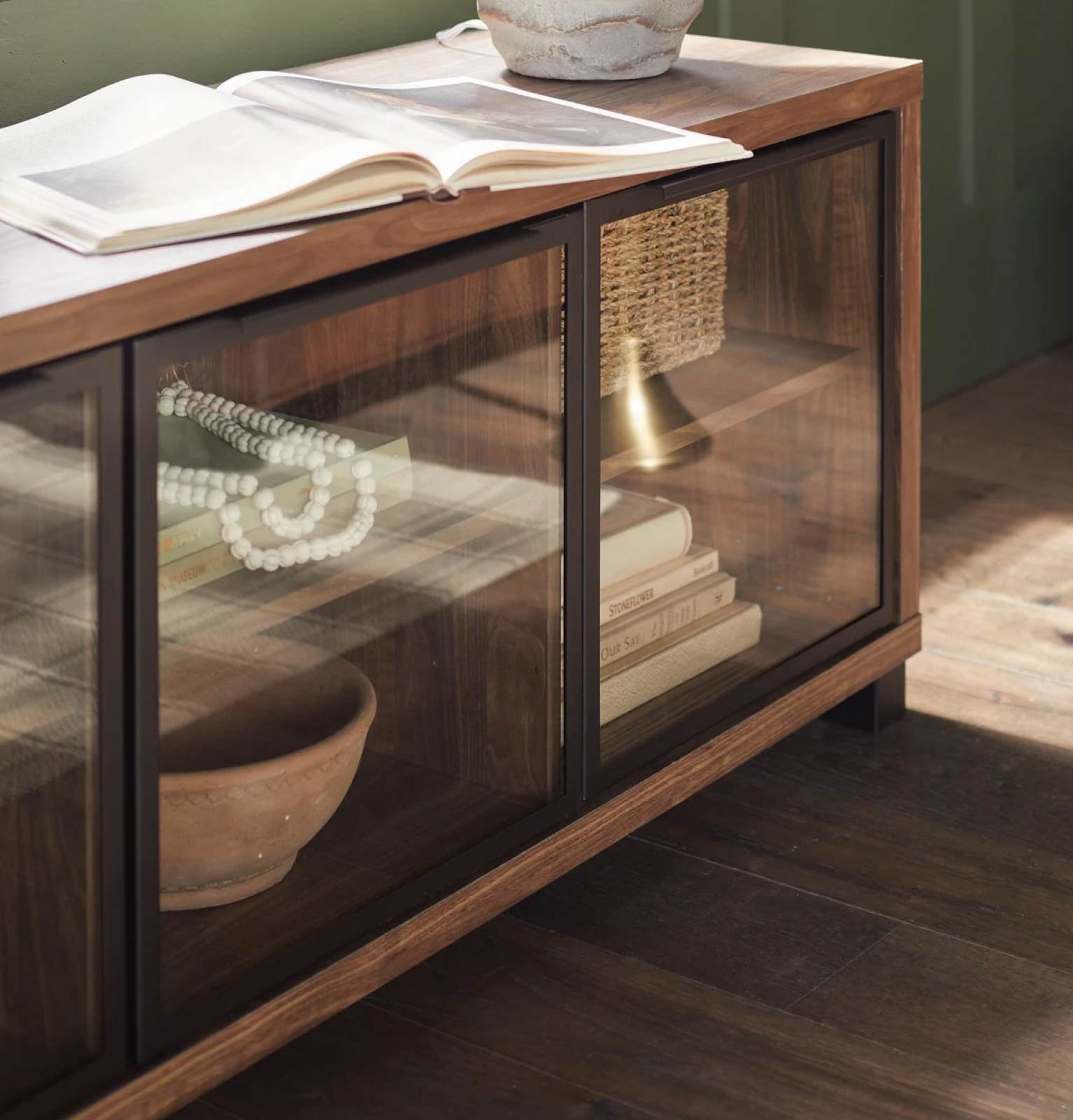 Brown woodgrain entertainment center with glass doors. Entertainment elevated. Shop now.