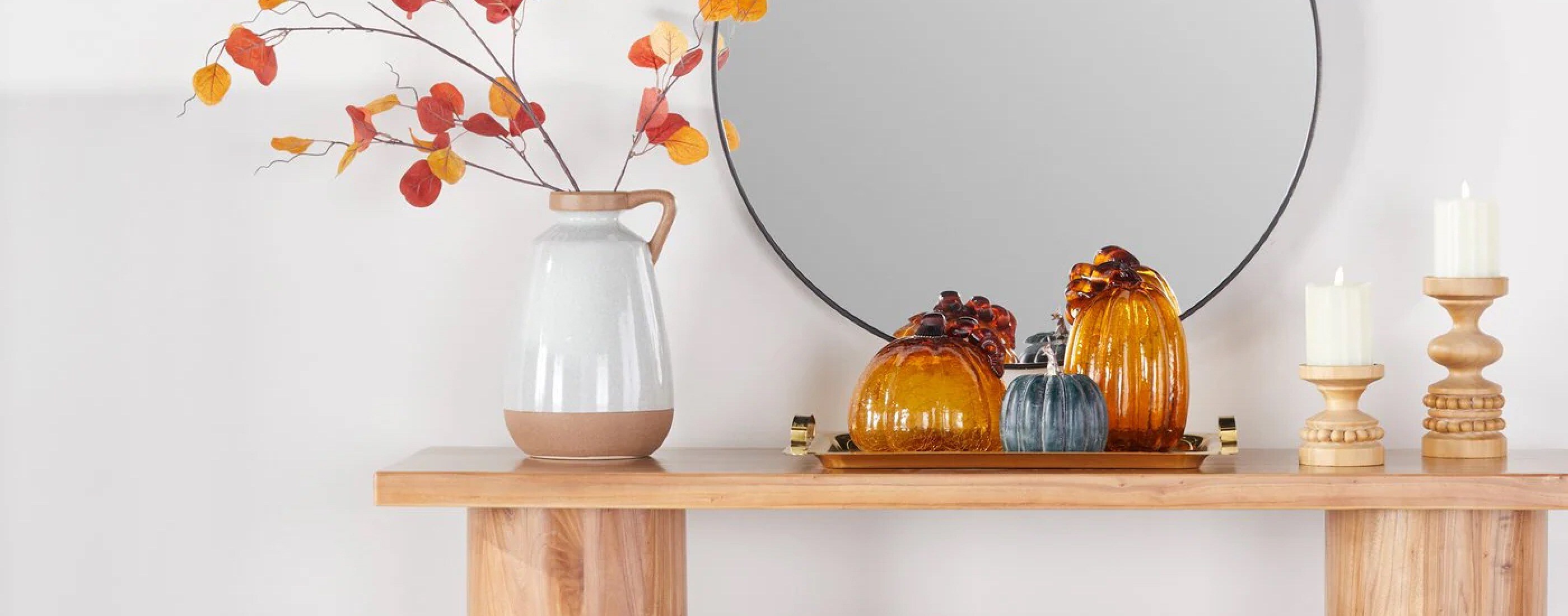 Natural wood console table with fall-themed decor, candles, and planter. Fresh fall decor from $19. Shop now.