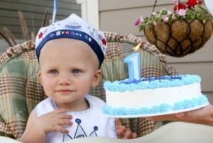 Baby boy wearing a bib at his first birthday party