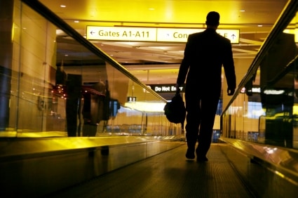 man hurries to his flight with his trusty travel bag