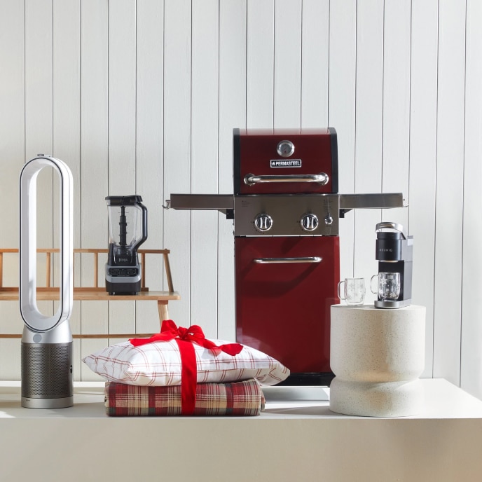 A display of giftable items, including a bladeless fan, a blender, a coffee maker, a pillow and blanket, and a grill.