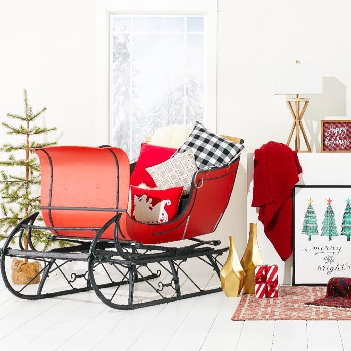 a santa sleigh filled with throw pillows available at overstock.com