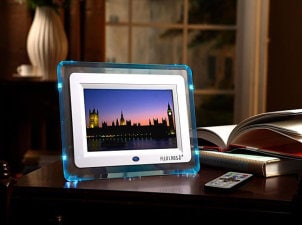 Blue rimmed digital photo frame lights up dark office