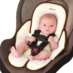 Cute baby sitting safely in a car seat