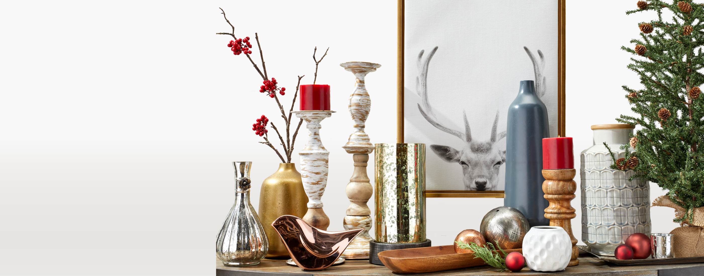 holiday candles, vases, and other decor on top of a table available online at Overstock