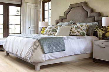 Protect Your Floors Upholstered headboard bed with wood-look laminate flooring