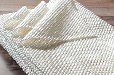Choose the Right Rug Pad Size Folded rug pad on hardwood floor