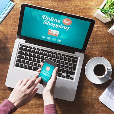 Get Up Early Woman looking at online shopping on her laptop and smartphone