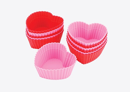 A set of heart shaped cupcake holders, a great bakeware gift for Valentine's Day
