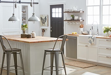 Kitchen with tall, rustic metal chair at a butcher-board kitchen island