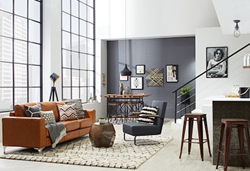 Modern, open-concept living room with leather couch and industrial metal accents