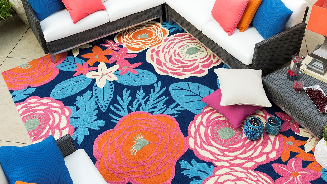 Aerial shot of bright patio furniture featuring an outdoor rug