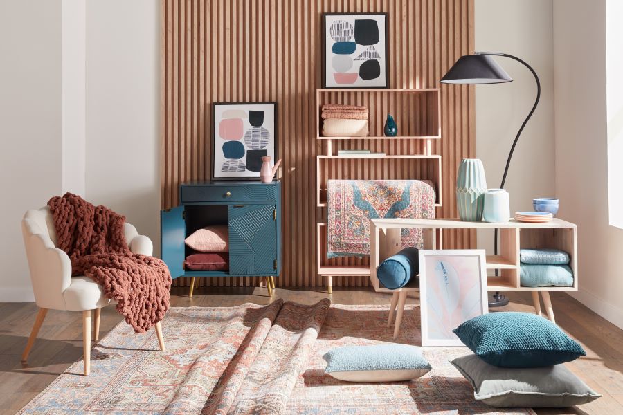 Display of chairs, rugs, throw pillows, and storage furniture