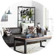 Industrial living room with a leather sofa, a mixed material coffee table, and a metal bookshelf