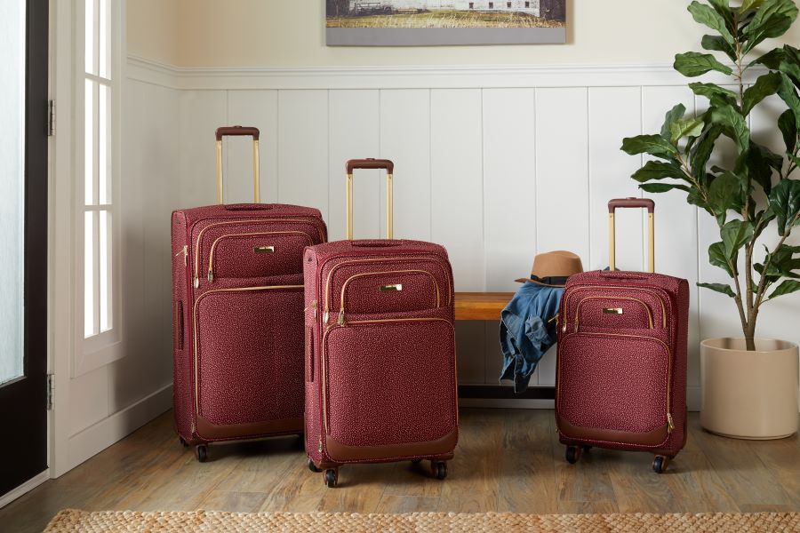 Red luggage set in an entryway
