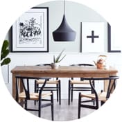 Scandinavian dining room with black and white wall art and a wooden dining set