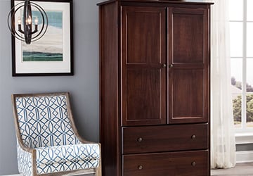 Tall wooden armoire with a reddish brown wood stain