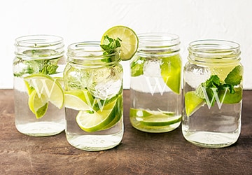 Monogrammed glass mugs with lime garnishes