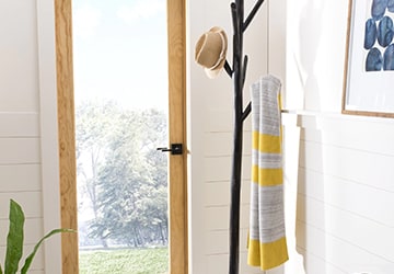 Coat rack with a hat and a scarf hanging from it