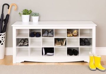 Shoe organizer with cubbies full of sandals, boots, and sneakers