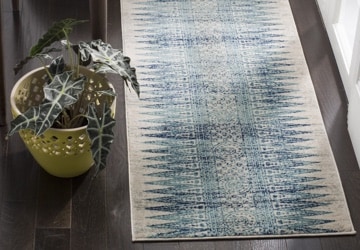 Runner rug with a geometric pattern in shades of blue, green, and cream