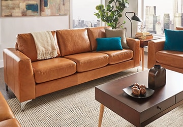 Brown sofas and loveseats gathered around a wooden coffee table