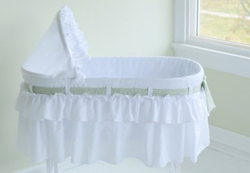 White bassinet in the corner of a nursery