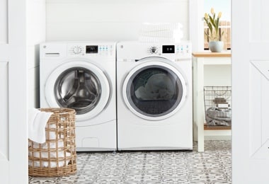 Laundry room with a washer, a dryer, and a laundry hamper