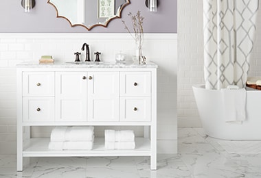 Bathroom with a white vanity and a soaking tub