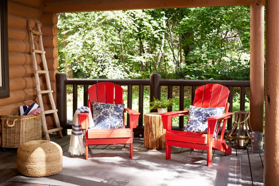 Red Adirondack chairs on cabin patio