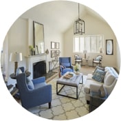 Living room with a mix of contemporary and traditional sofas, tables, and lighting